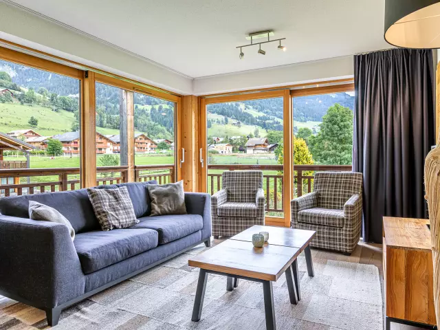 Apartment with large bay windows, sofa and coffee table