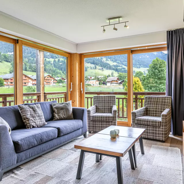 Apartment with large bay windows, sofa and coffee table