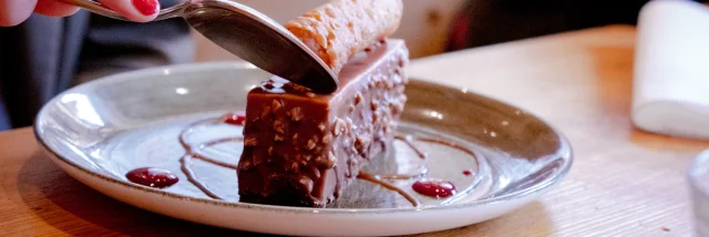 A chocolate entremet on a white plate